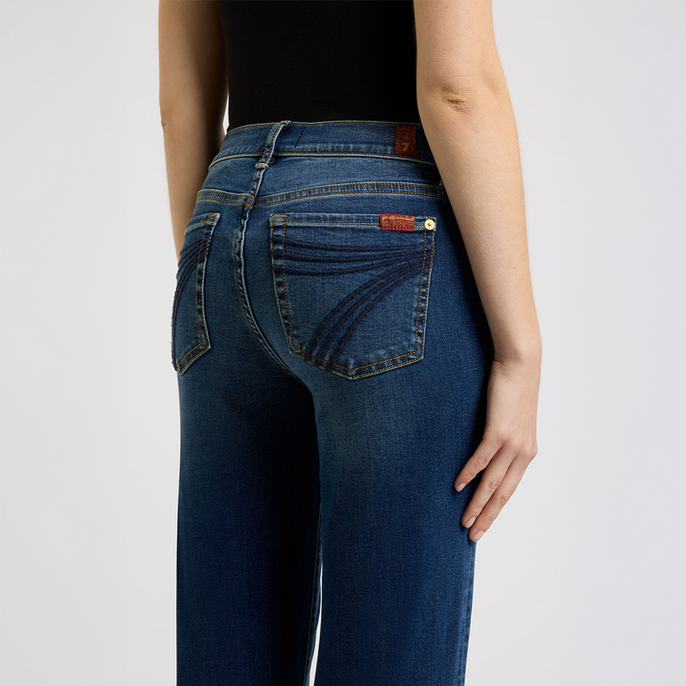 Person wearing   DOJO Melrose Blue jeans on a plain background