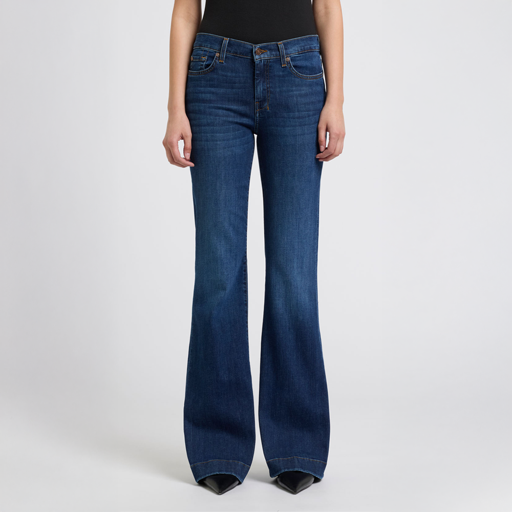 DOJO Rebellion Blue flared jeans worn by a person on a white background